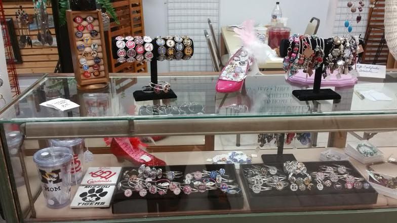 A glass display case filled with jewelry and watches