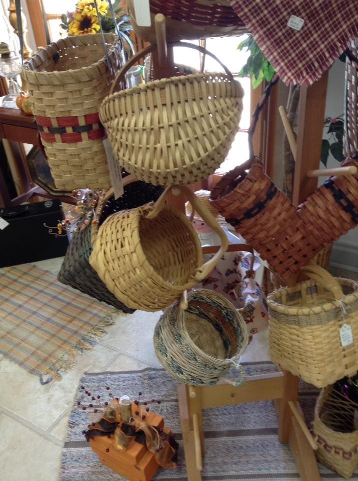 A bunch of baskets are hanging on a rack in a room.