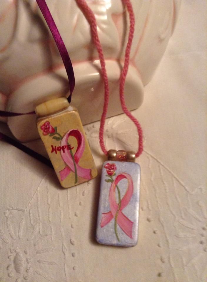 A necklace with a pink ribbon and the word hope on it