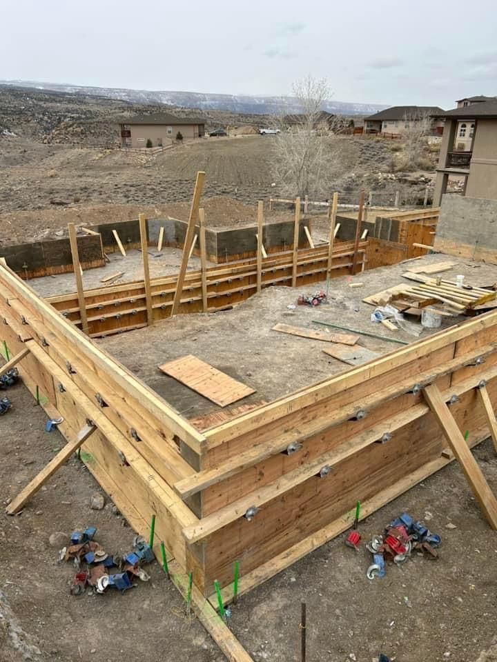 Wooden forms for foundation construction on a sloped lot.