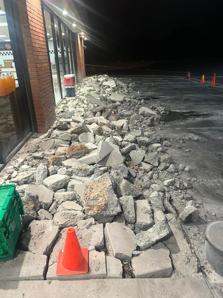 Debris pile next to a brick building at night.