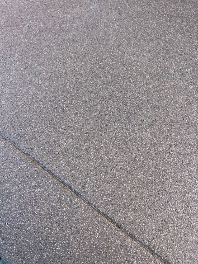 Gray asphalt surface with a diagonal crack.