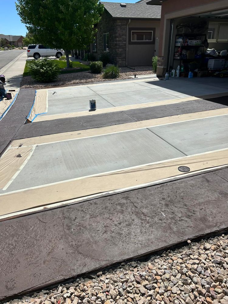Concrete driveway with stamped border and decorative rectangular sections.