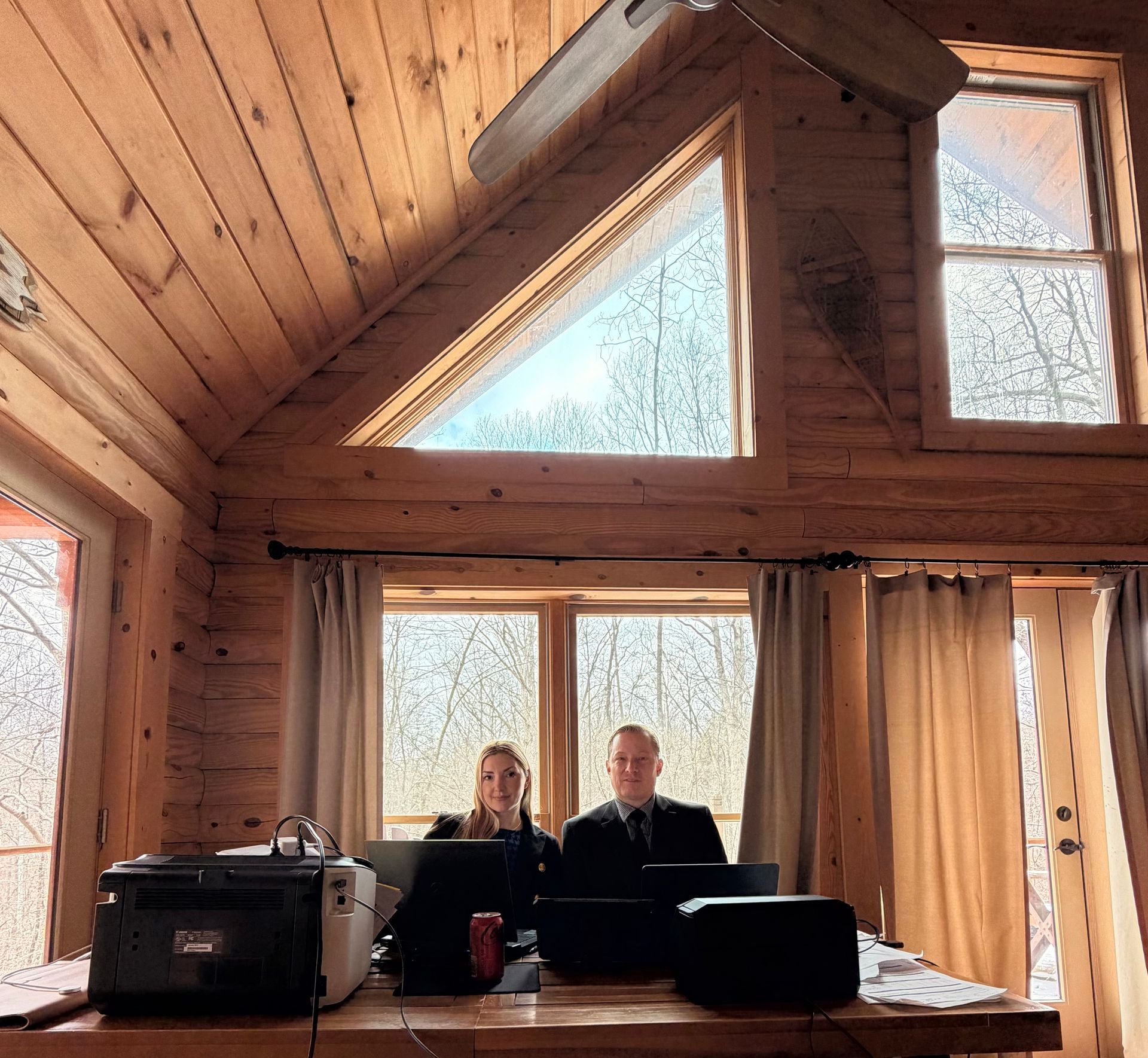Lynn Law Group attorneys working remotely from a cabin during spring break, handling simultaneous 341 meetings of creditors with full mobile office setup.