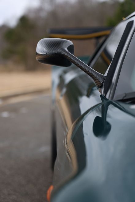 A close up of a car 's side mirror on a road