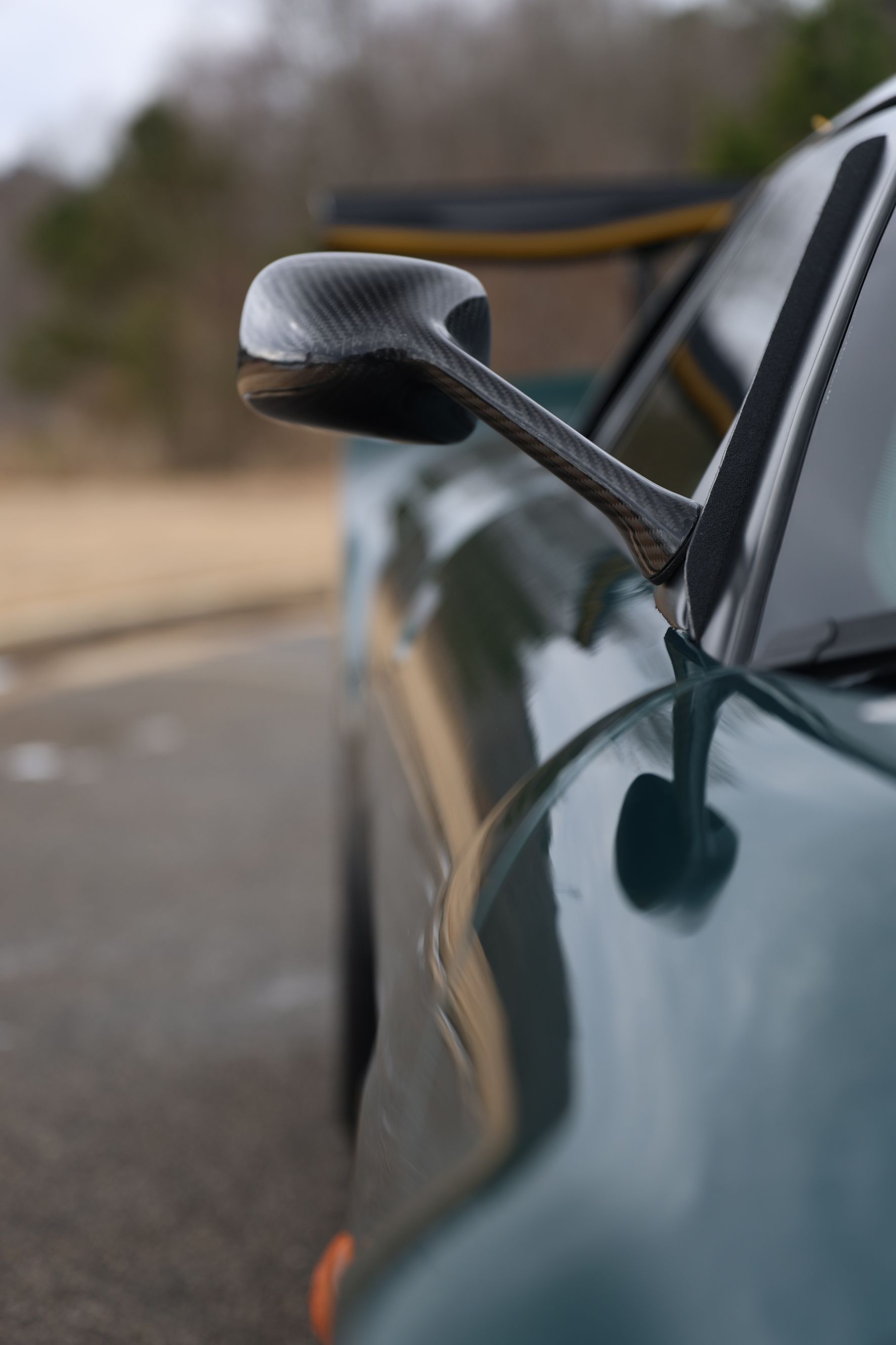 A close up of a car 's side mirror on a road