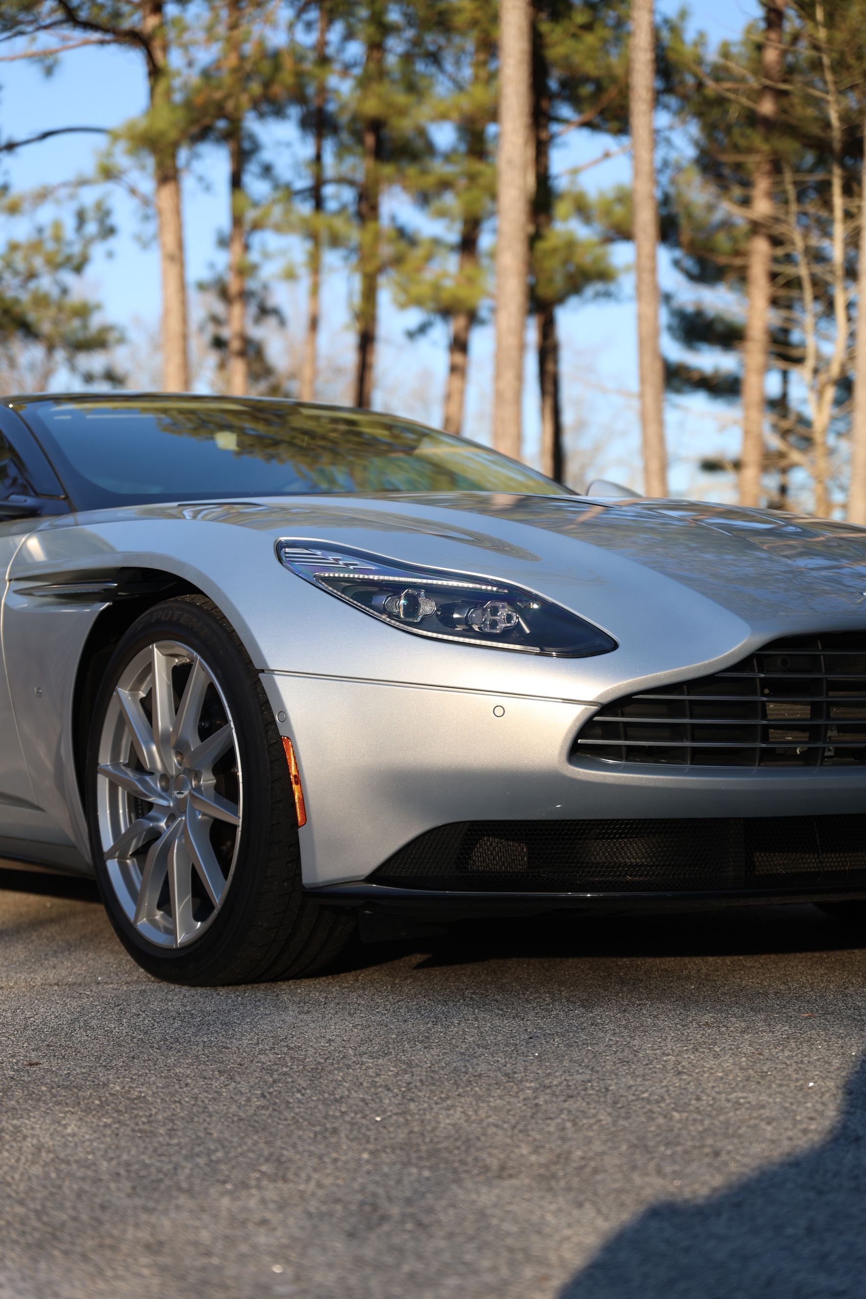 A close up of the back of a car with a blue sky in the background.