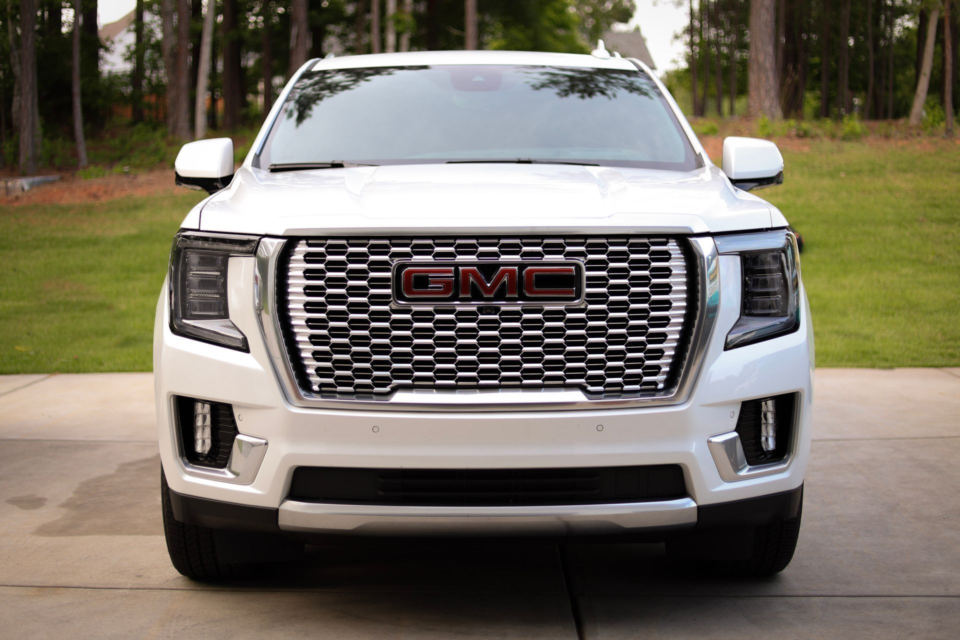 A man is washing a sports car with foam.