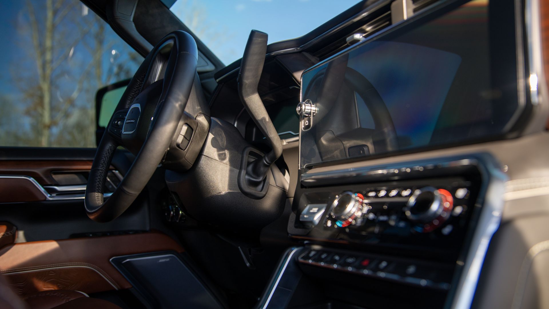 A close up of the steering wheel and dashboard of a car.