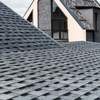A close up of a roof with shingles on a house.