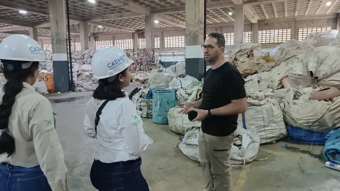 Burger, onion rings, and fries on a red table with a 