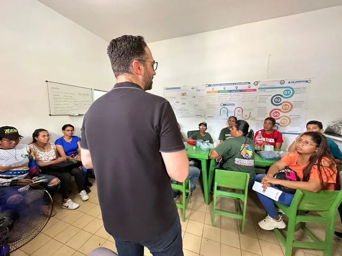 Hands holding a wrapped burger, fries, and nuggets with a sesame bun in front of a colorful backdrop.
