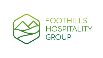 The logo for foothills hospitality group is a green hexagon with mountains in it.