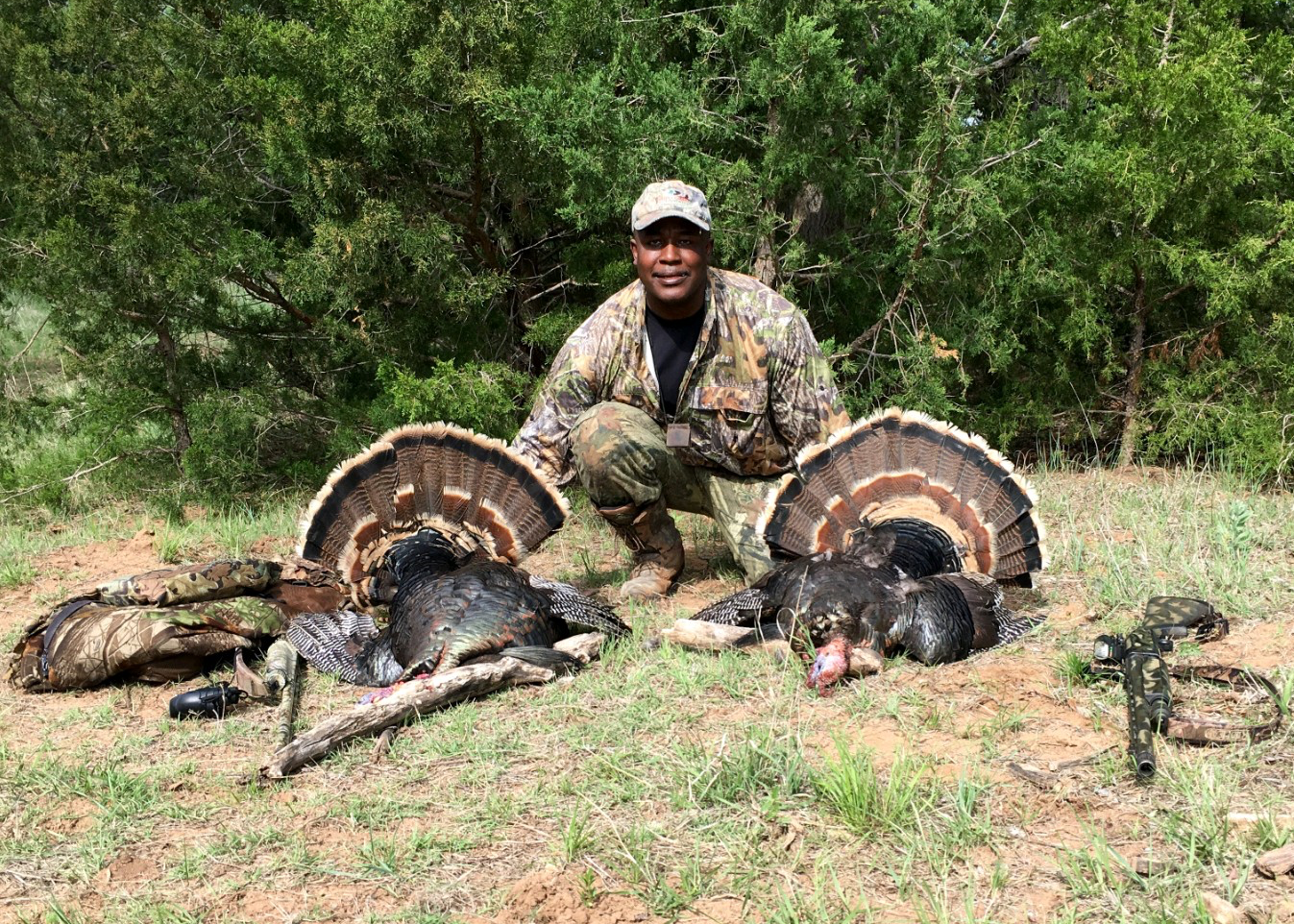 Ken S. showing off two turkeys harvested on a Salt Fork Hunt