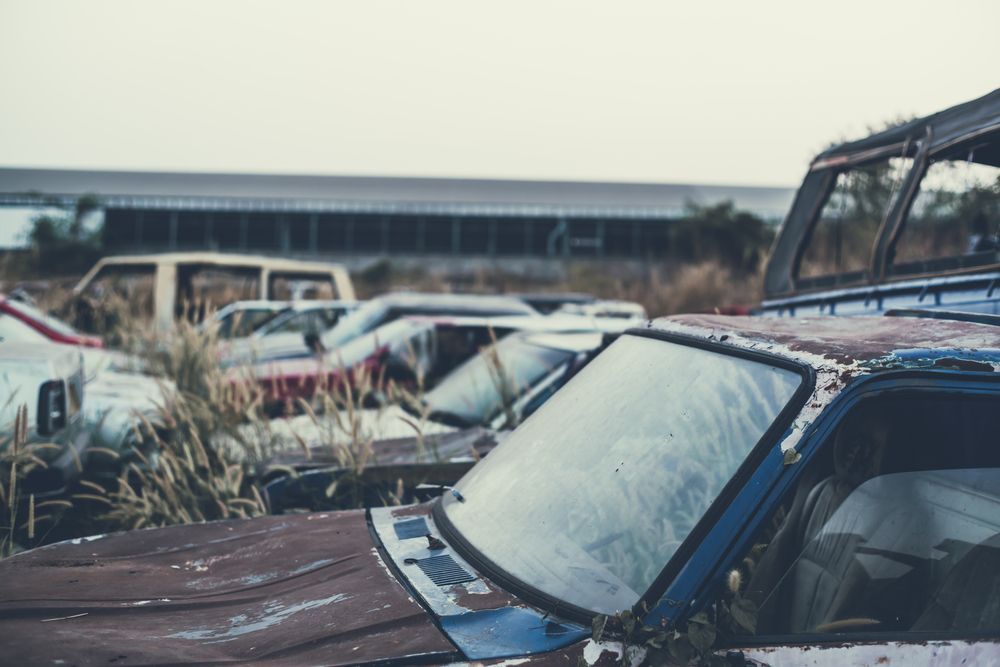 A Bunch Of Old Cars Are Parked In A Field — East Coast Metal Recycling In Redland Bay, QLD