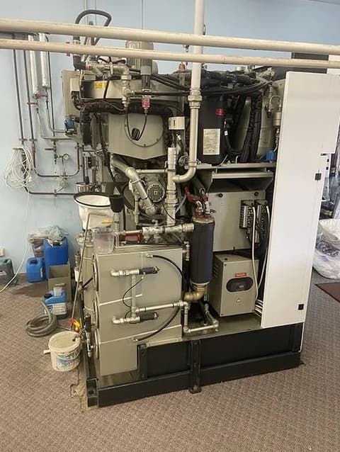 A Large Machine Is Sitting In A Room With A Lot Of Pipes — East Coast Metal Recycling In Brisbane, QLD