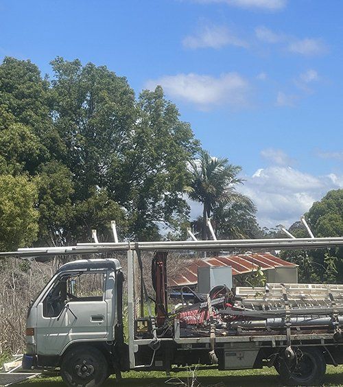 A White Truck With A Ladder On Top Of It — East Coast Metal Recycling In Tugun, QLD