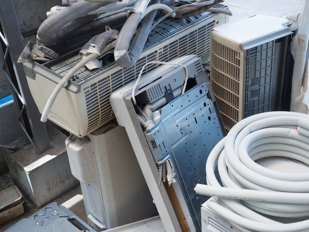 A Bunch Of Old Appliances Are Sitting On Top Of Each Other On The Ground — East Coast Metal Recycling In Tugun, QLD