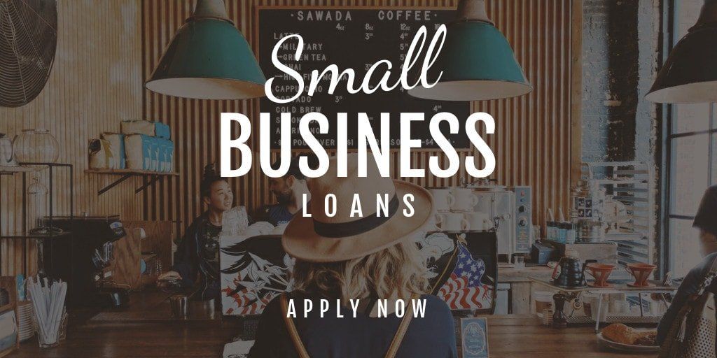 A woman in a hat is sitting at a table in a small business.