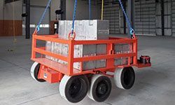 A cart with boxes on it is sitting in a warehouse.