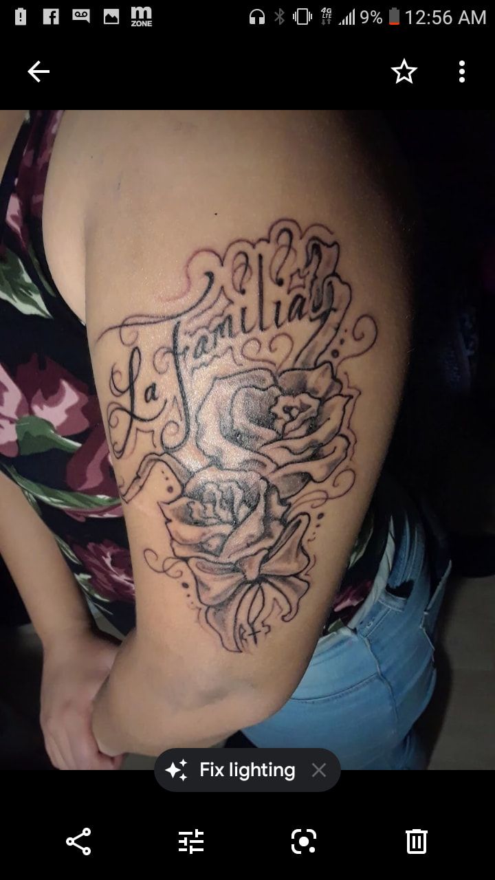 A woman has a tattoo on her arm that says la familia