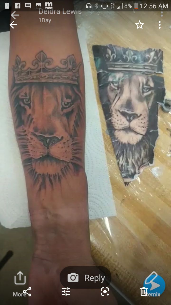 A tattoo of a lion with a crown on its head
