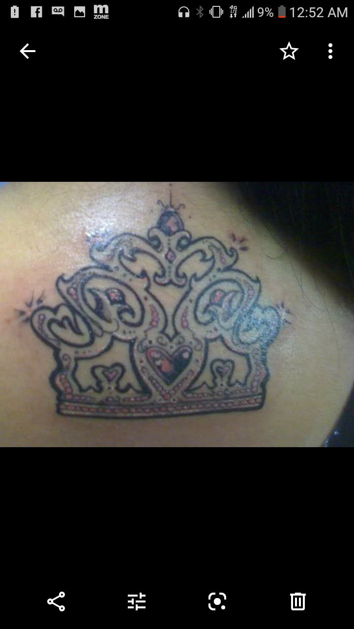 A woman has a tattoo of a crown on her back
