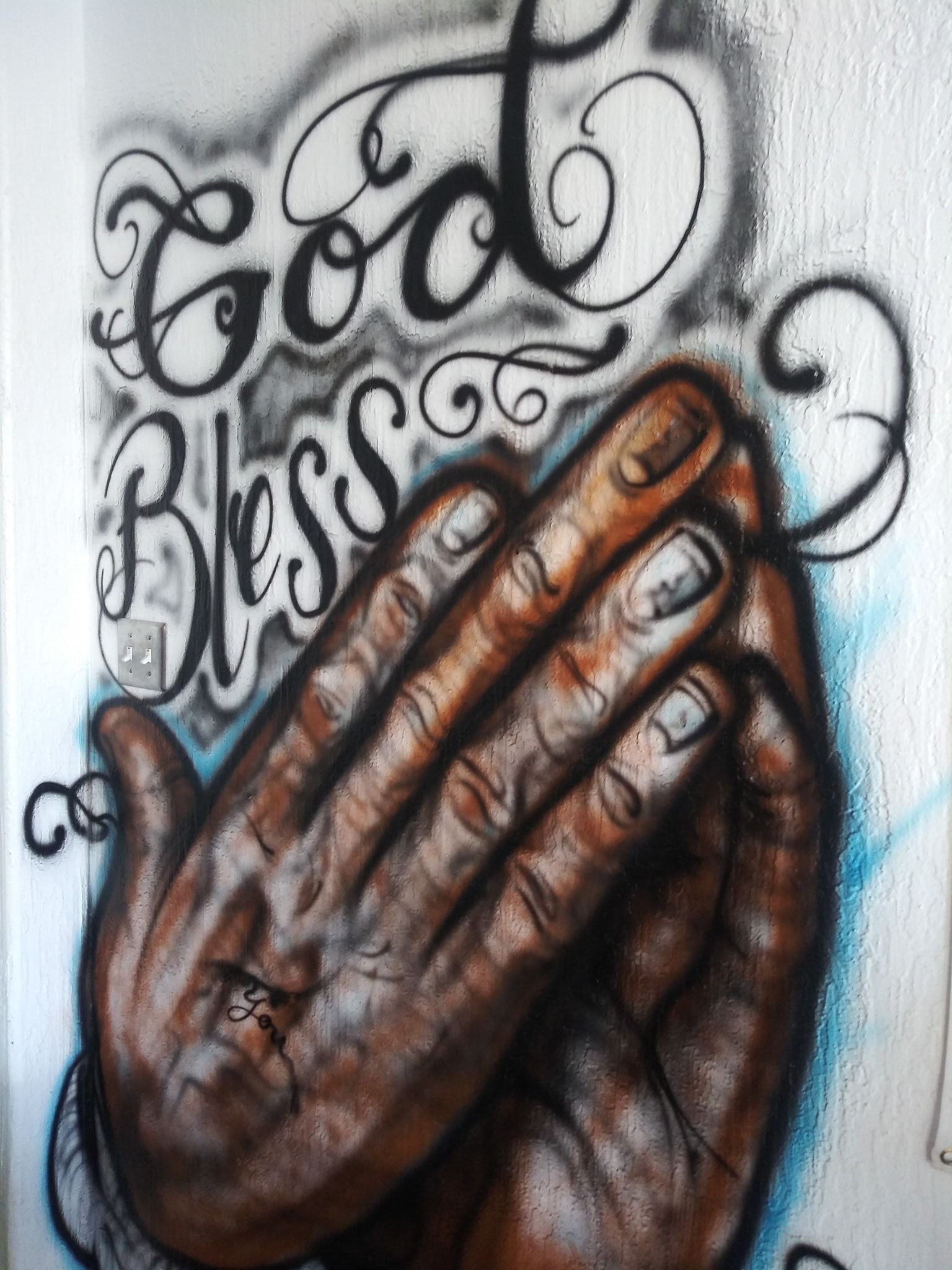 A painting of praying hands with the words god bless on it