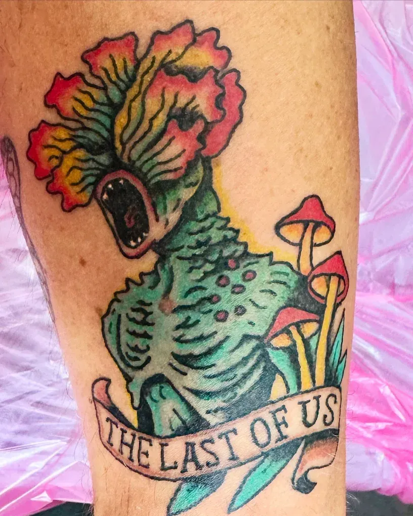 A tattoo on a person 's leg that says the last of us