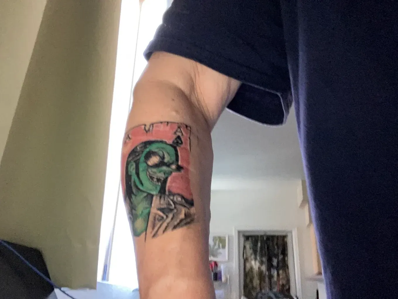 A person has a tattoo on their arm of a duck