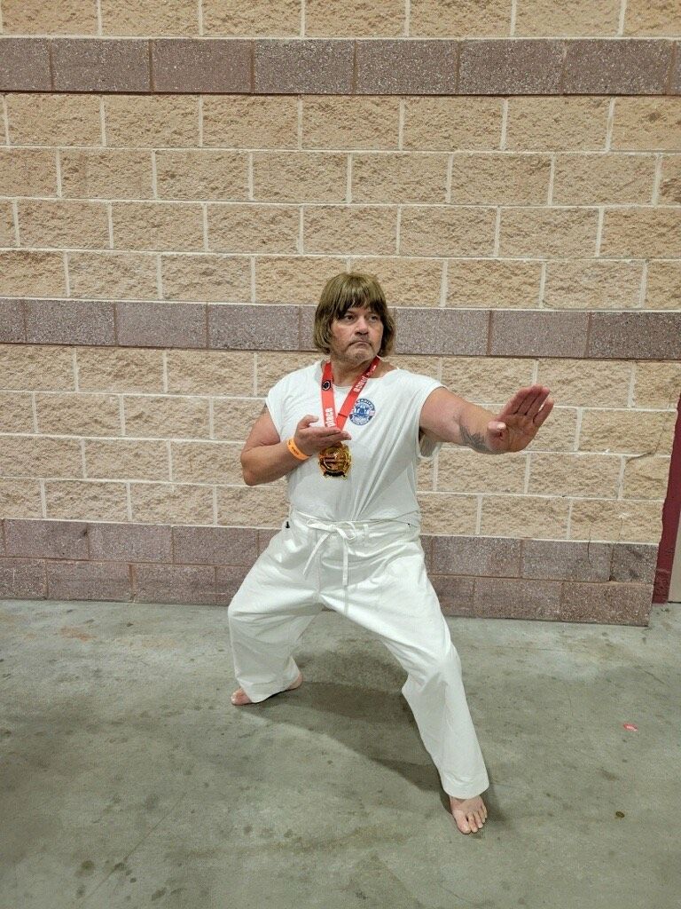 Adults practicing karate drills at Karate World in Kenilworth, NJ to build strength, balance, and focus.
