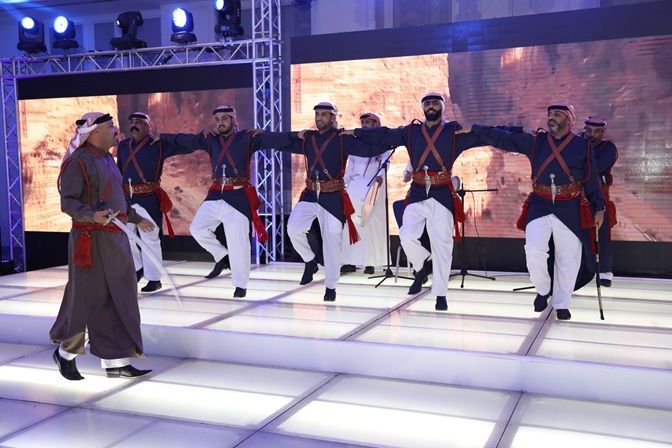 Exterior view of Gelora Bung Karno Stadium in Jakarta, Indonesia, with a circular design, and a cityscape backdrop.
