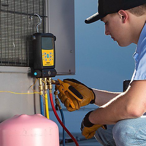 Man Checking Heating and Cooling Machine — Dade City, FL — Environmental Contractors Heating and Air Conditioning