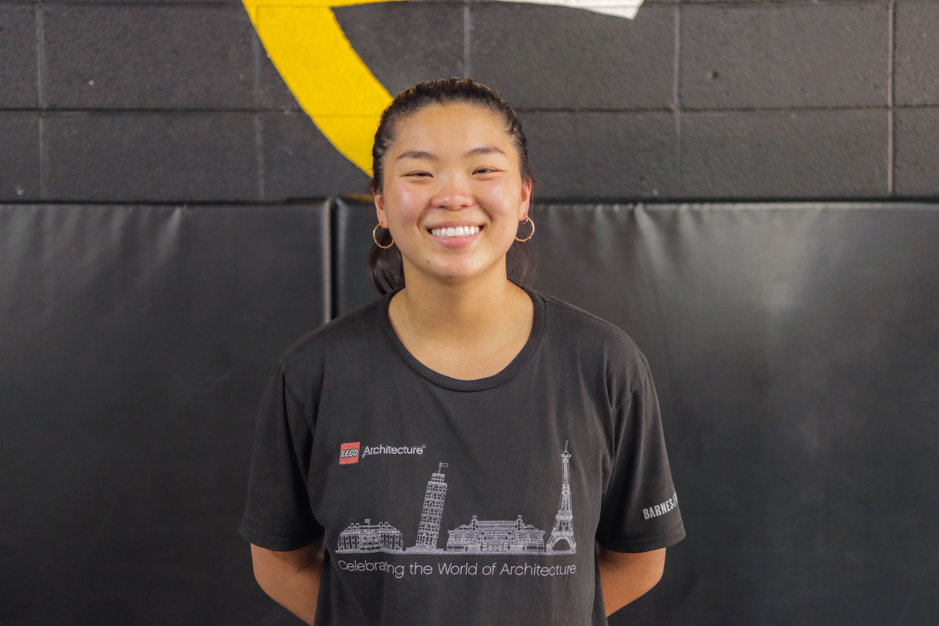 A young woman wearing a black shirt is smiling for the camera.