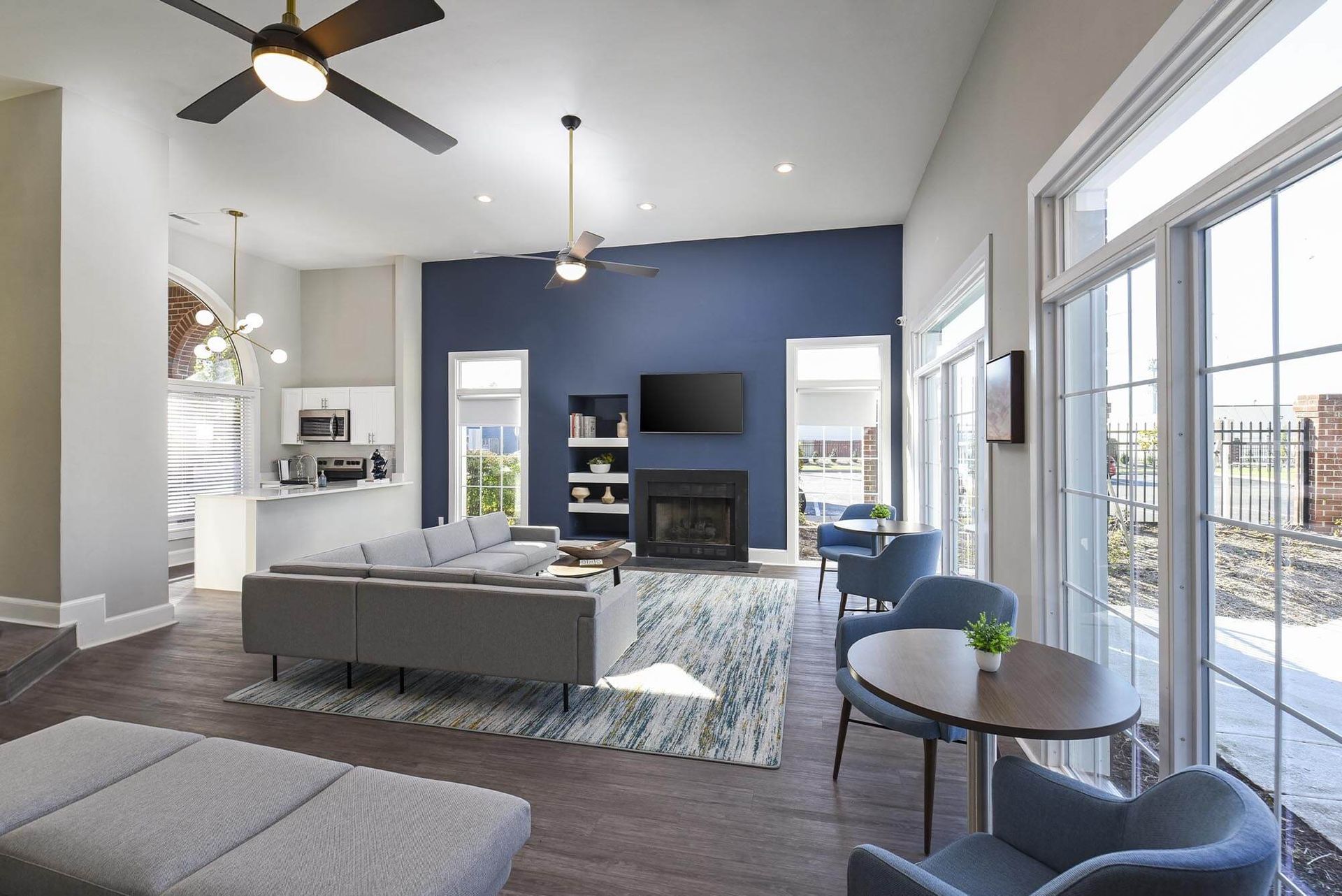 Spacious living lounge with a blue accent wall, fireplace, and large windows.