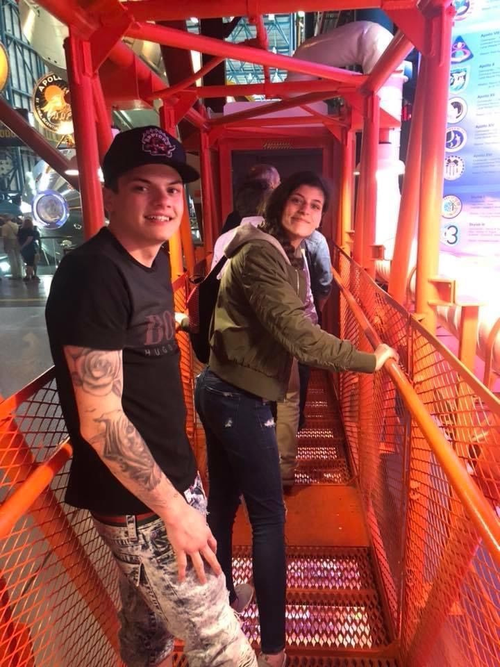 A man and a woman are standing on a set of stairs