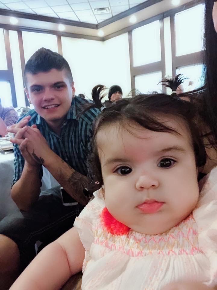 A man and a baby are posing for a picture