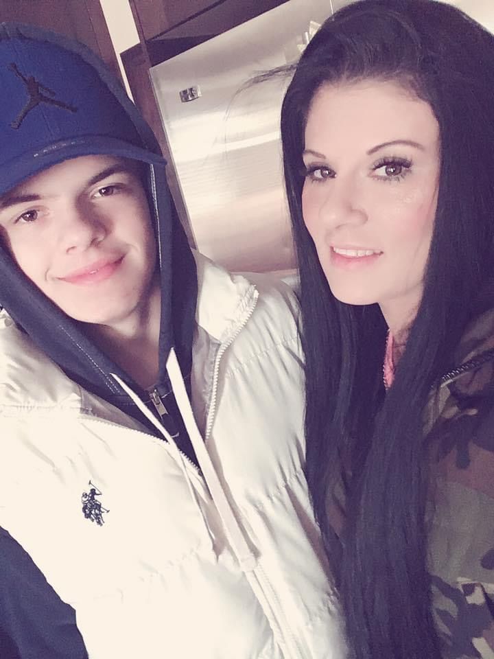 A boy and a girl are posing for a picture together