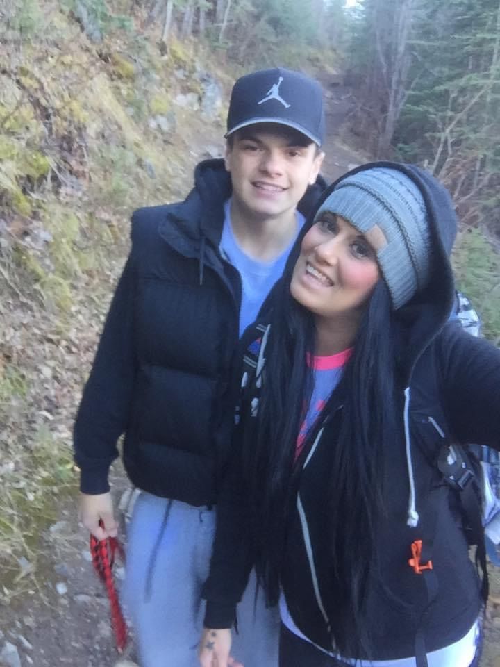 A man wearing an air jordan hat stands next to a woman