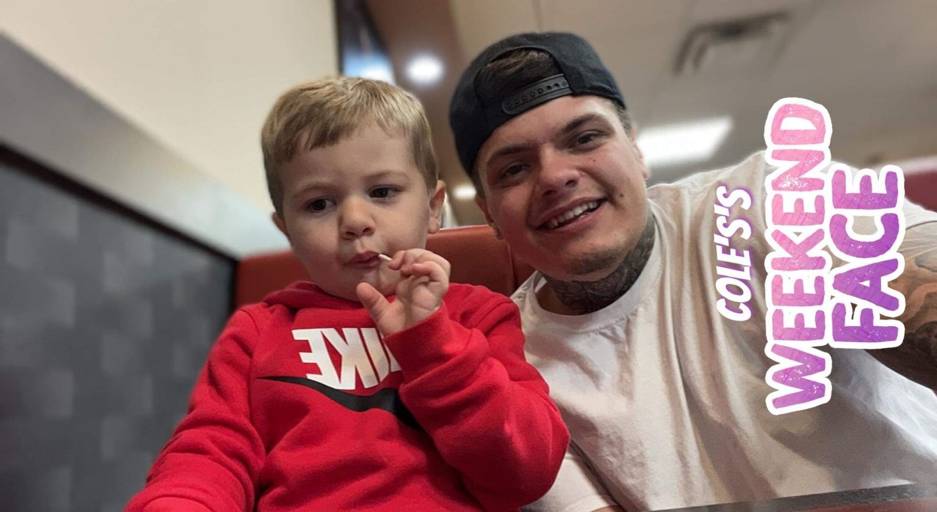 A man and a little boy are sitting next to each other in a restaurant.