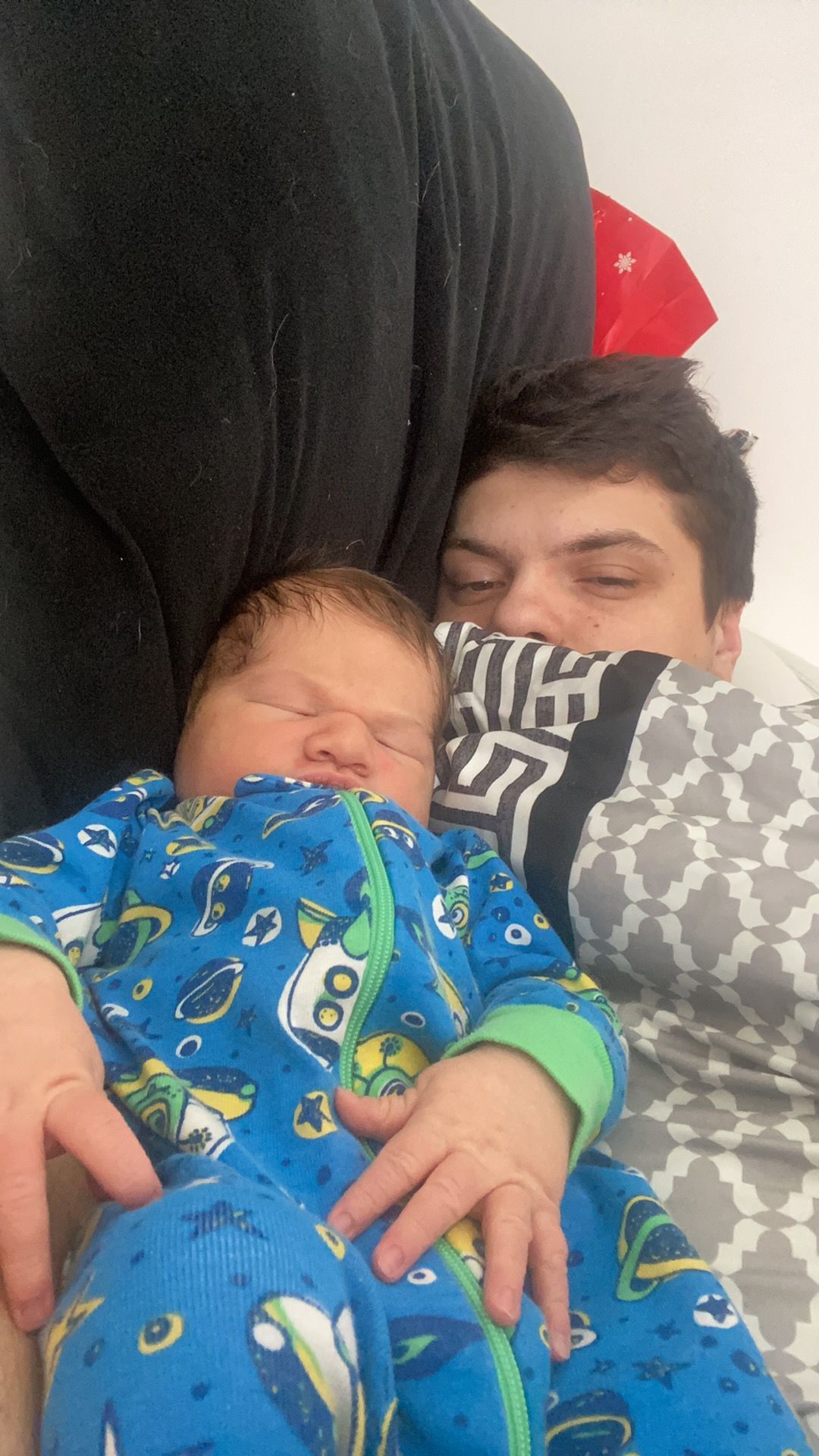 A man is holding a baby in his arms.