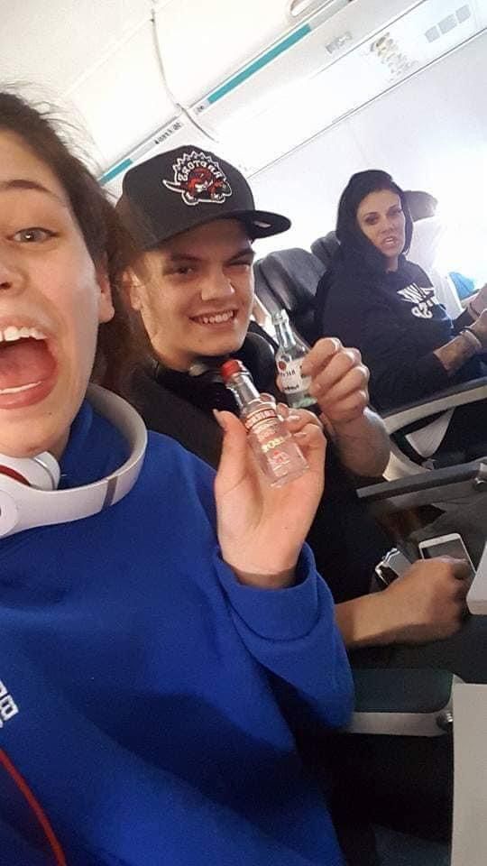 A group of people are sitting on an airplane.