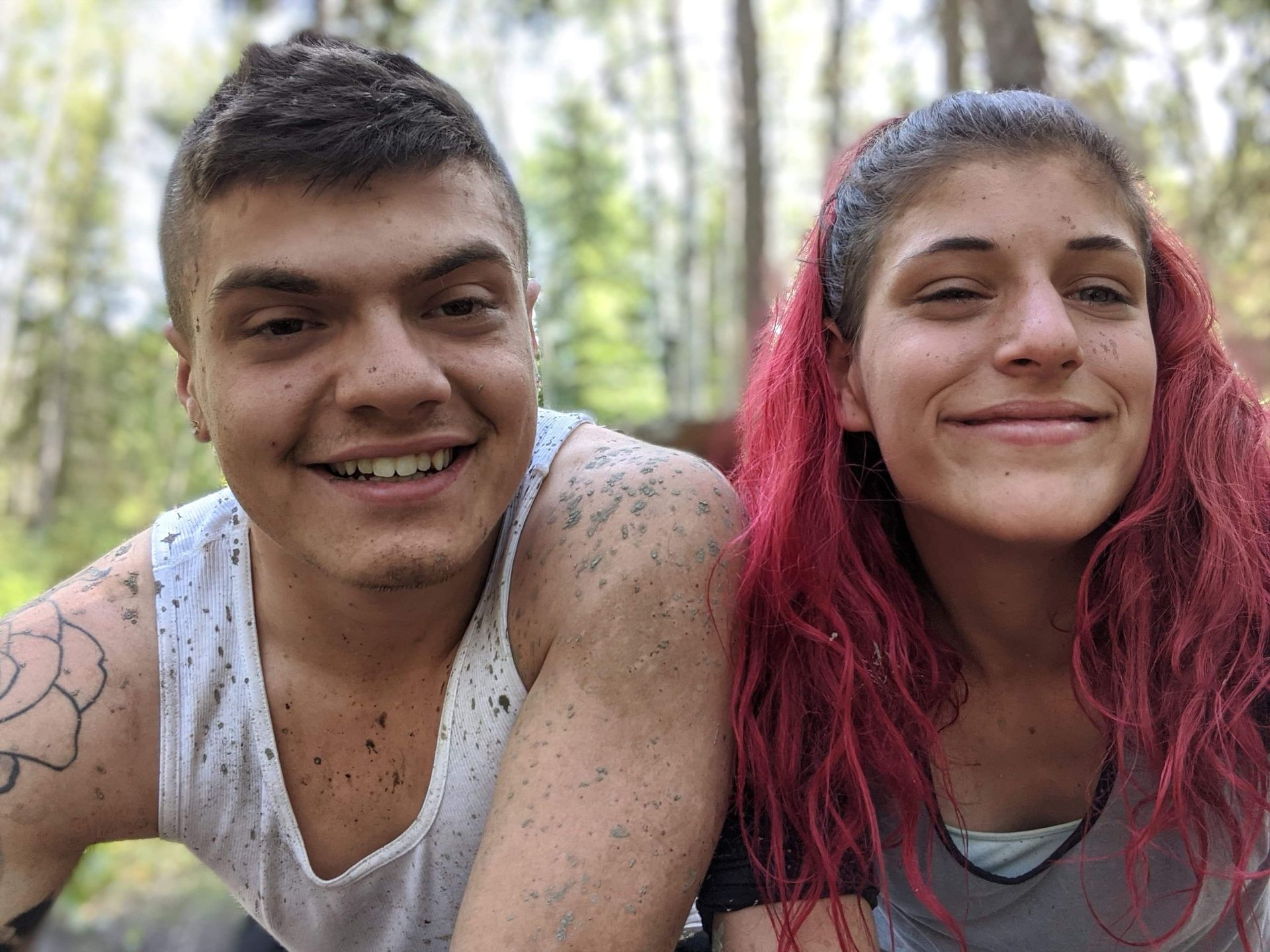 A man and a woman with red hair are posing for a picture.