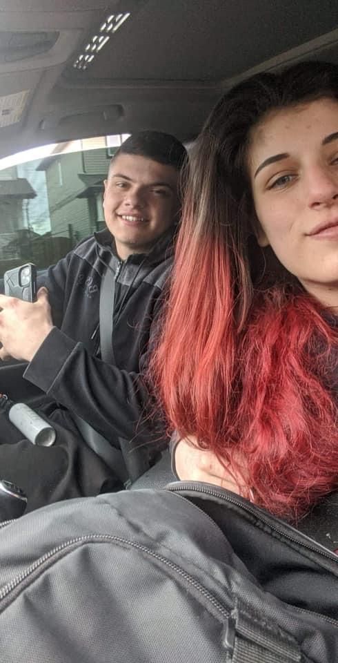 A man and a woman are sitting in a car . the woman has red hair.