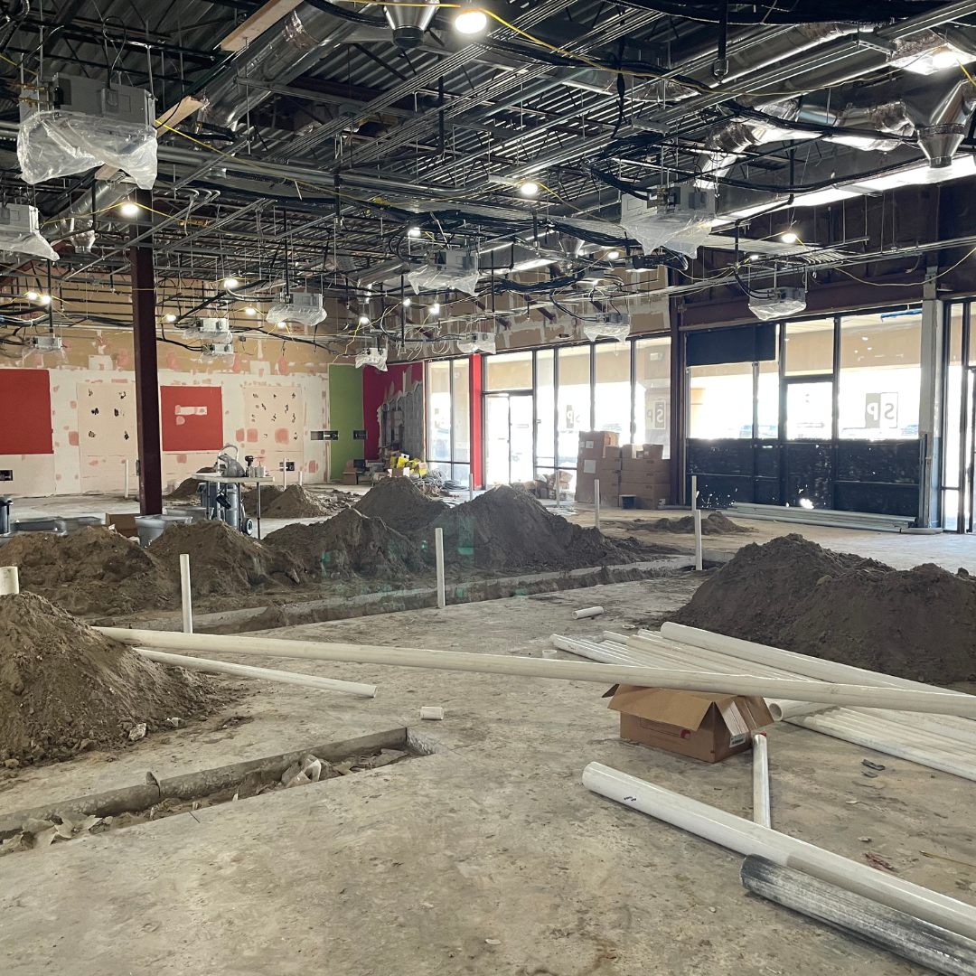 An empty salon suite after the demolition phase of construction. 