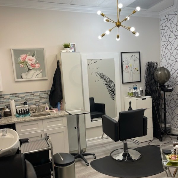 A hair salon with a chair and a sink