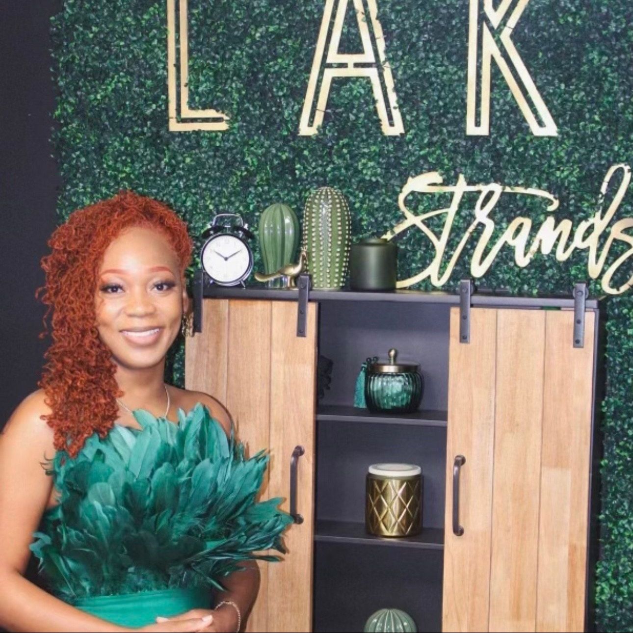 A woman in a green dress is standing in front of a sign that says lak trends