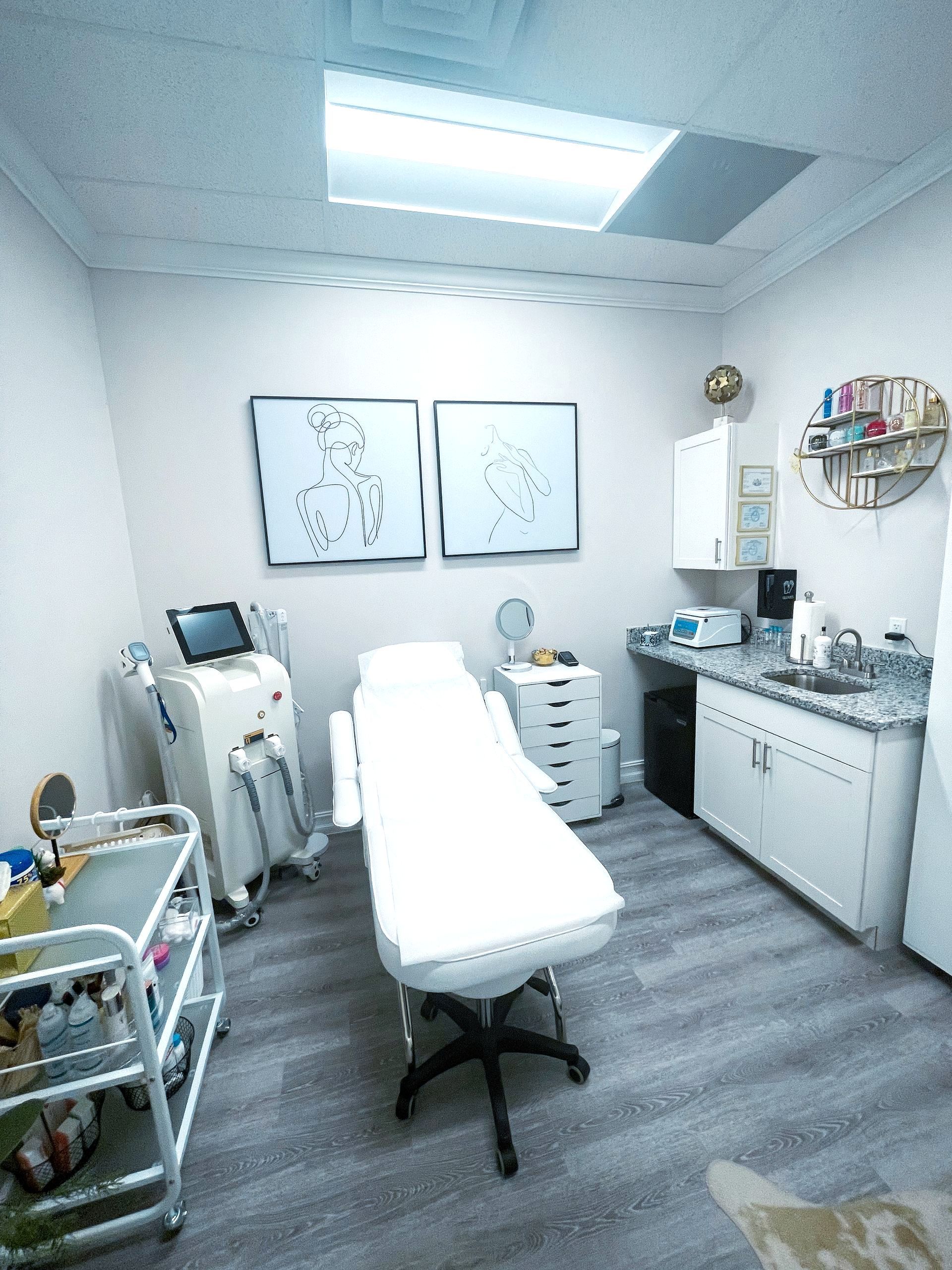 A room with a bed , a sink and a paintings on the wall.