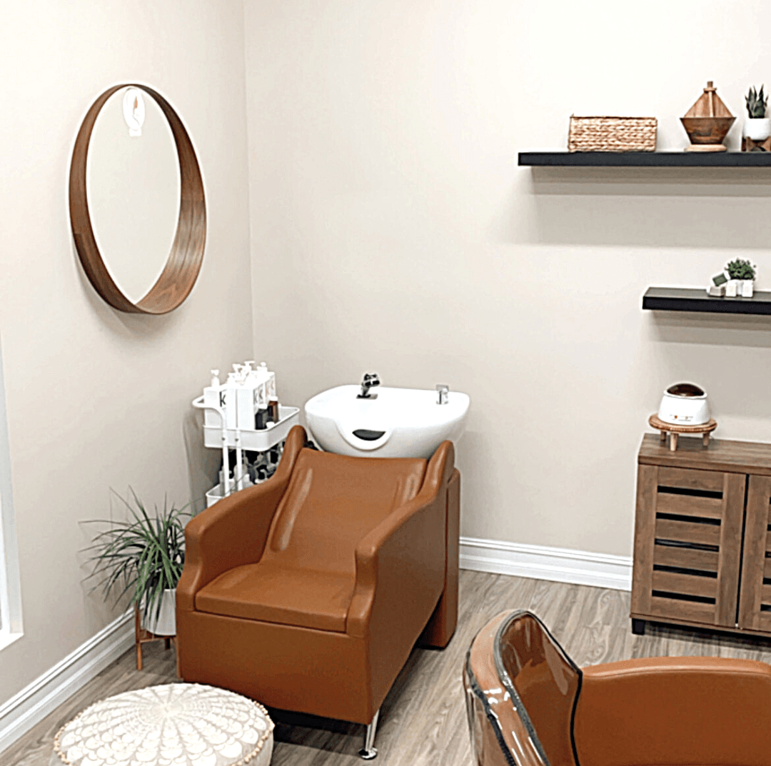 There is a chair and a sink in the room.