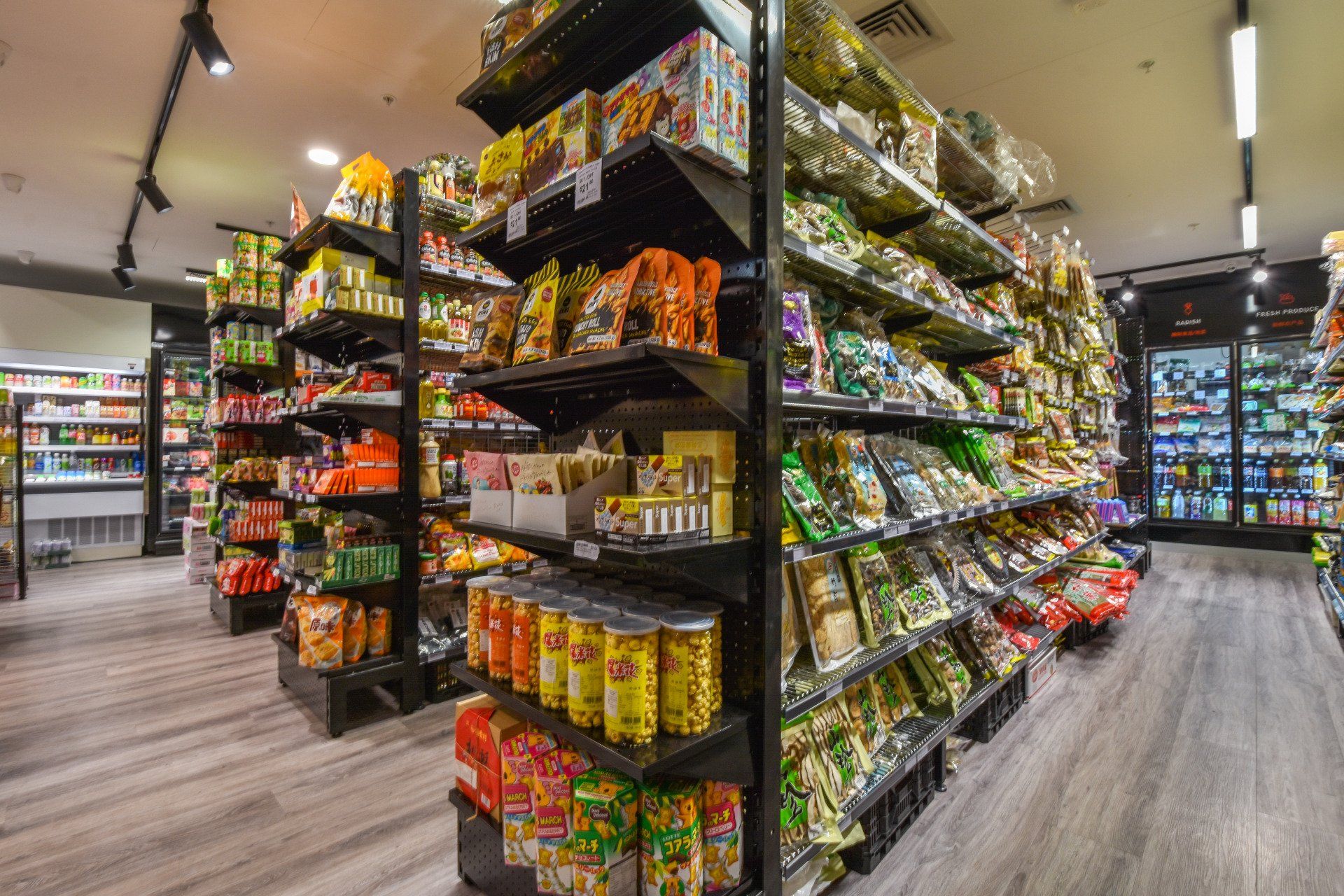 Grocery store shelves packed with various packaged snacks and products.